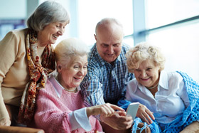 Four people looking at a phone